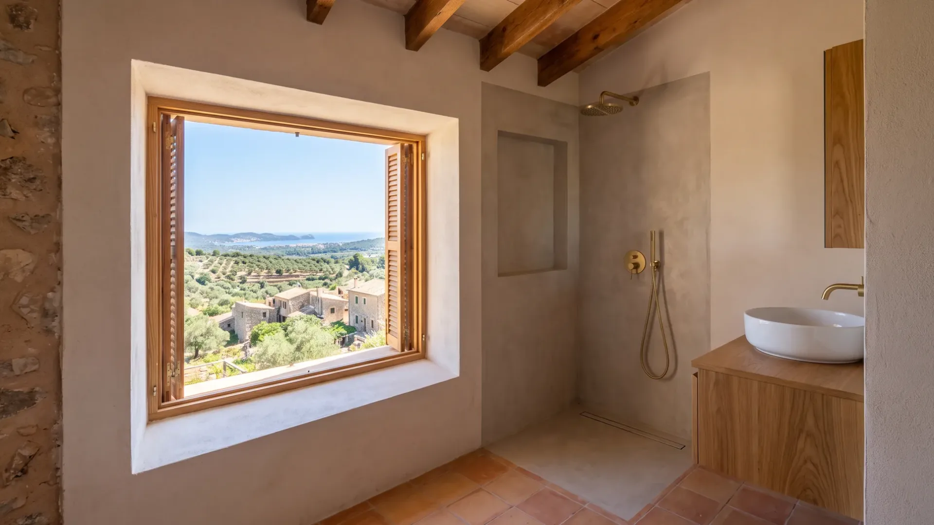 A pale stone bathroom pairs a floating vanity below a wide window with a glass walk in shower lit by a shaft of sunlight.
